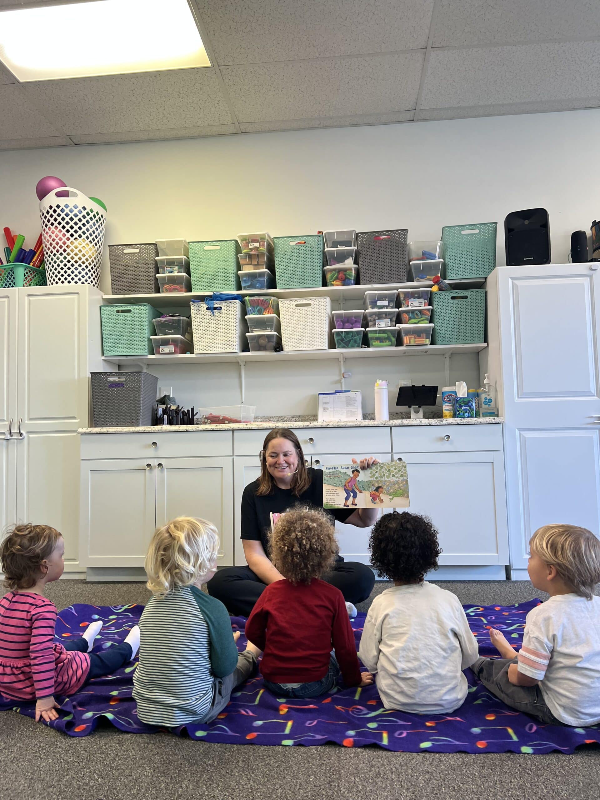 Children and caregivers singing and playing together with instruments at a Melody Magic Playdates class